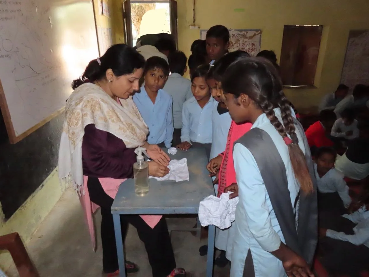 Watershed demonstration with crumpled paper and a spray bottle at a school session