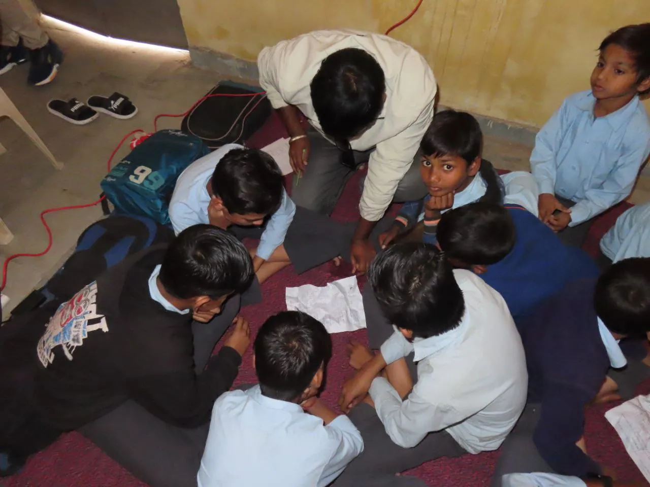 Students solving a group activity on the classroom floor