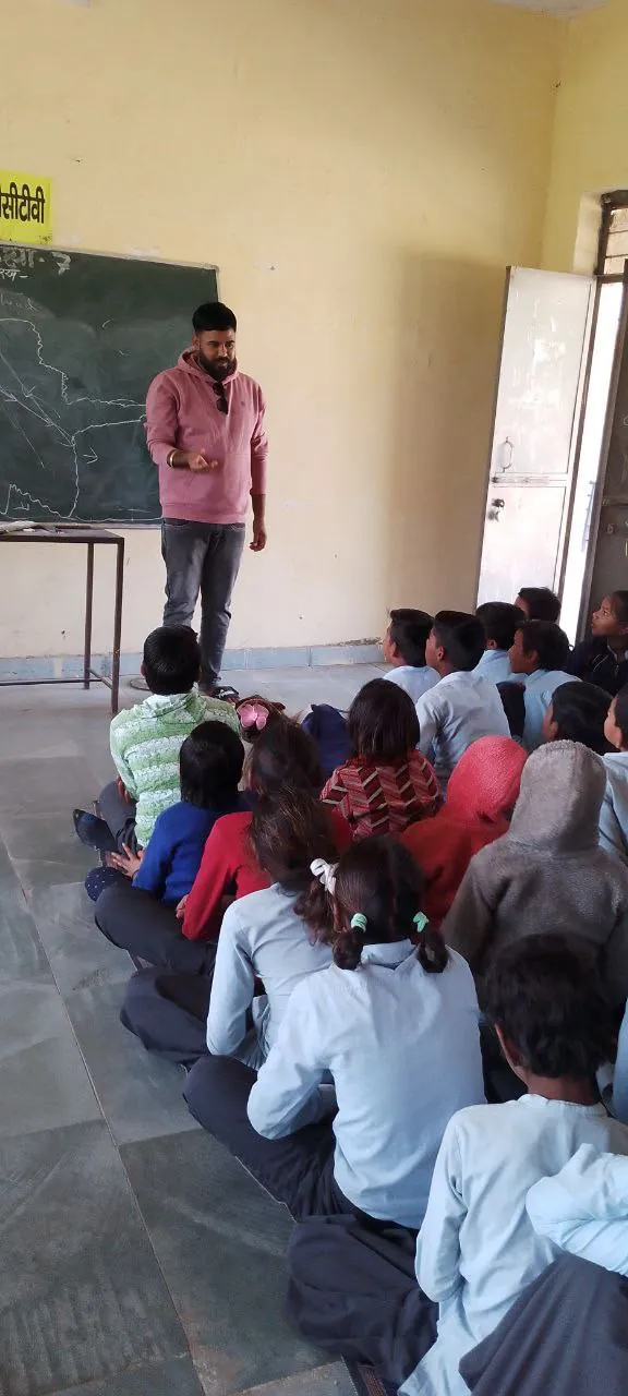 Team member talking with students in class